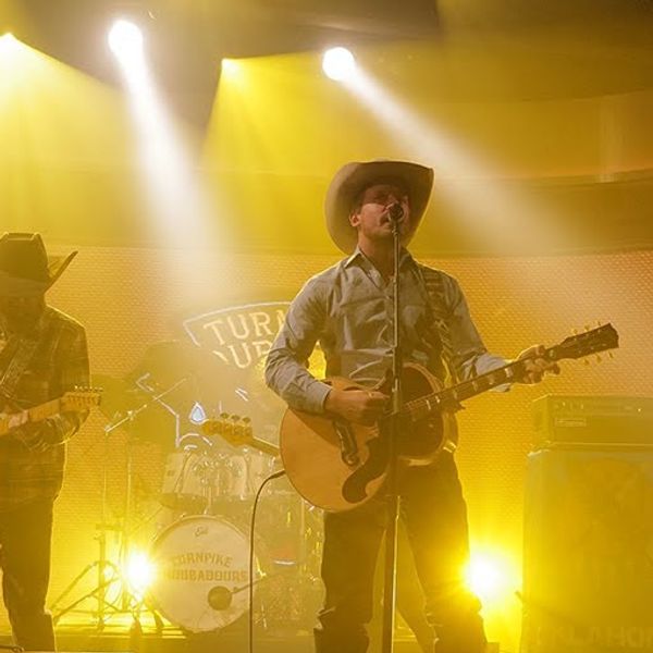 Turnpike Troubadours on Jimmy Kimmel Live Stage performing under yellow stage light.