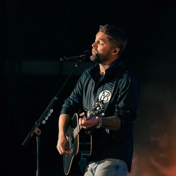 Brett Young performing live in a black hoodie