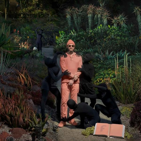 Bon Iver standing in a jungle with figurines holding him