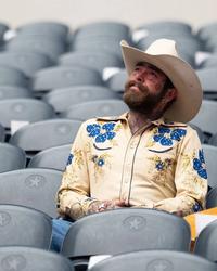 Post Malone sat in the stands of a stadium
