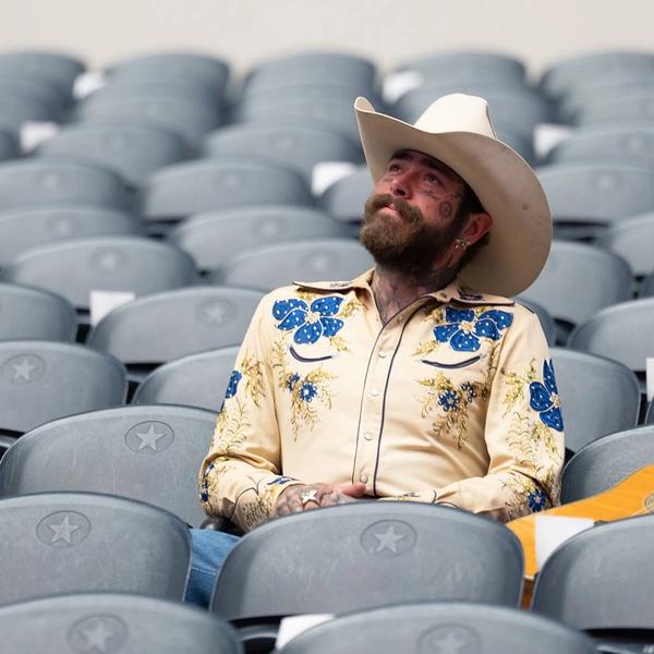 Post Malone sat in the stands of a stadium