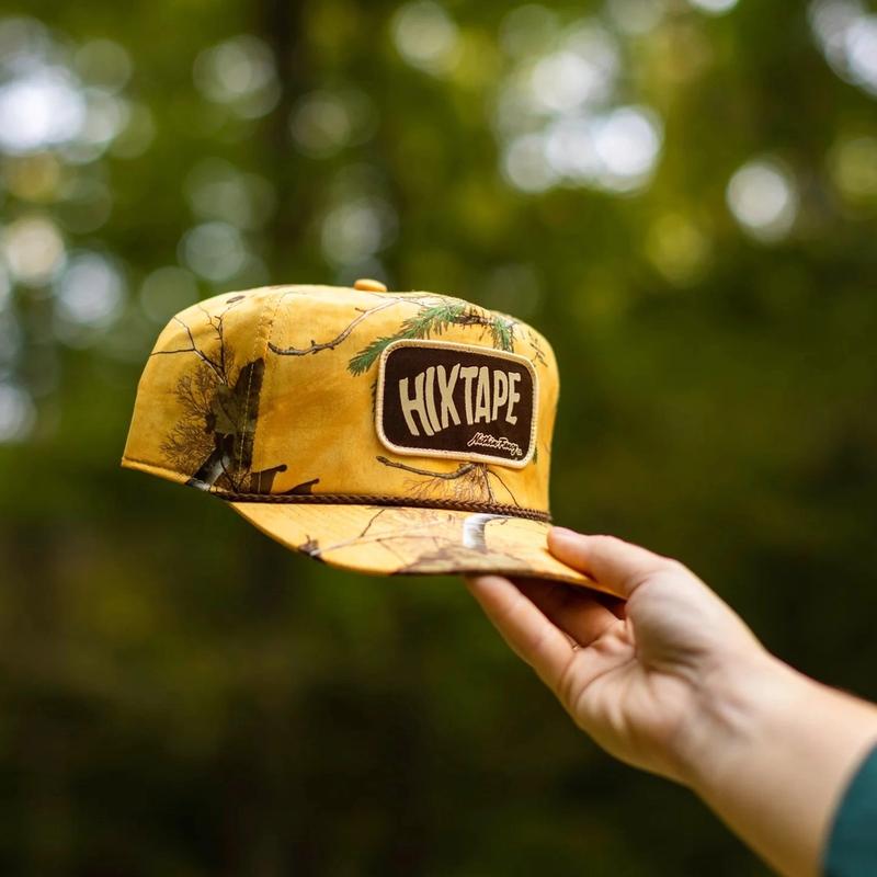 <p>Someone holding a yellow HIXTAPE x Nuthin Fancy Collaboration Hat</p>