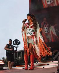 Ella Langley singing into a microphone on stage at Stagecoach Festival 2026.