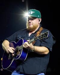 Luke Combs wearing a green NY hat