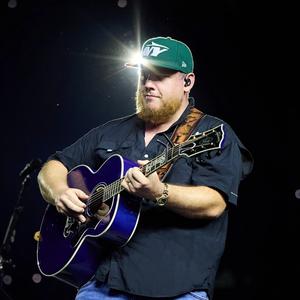 Luke Combs wearing a green NY hat