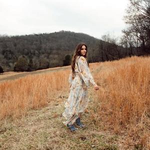 Brit Taylor looking back in a field