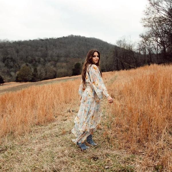 Brit Taylor looking back in a field