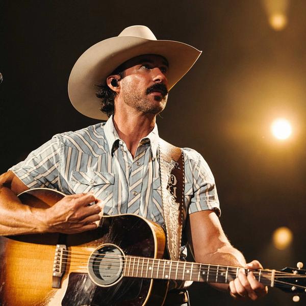 Riley Green wearing a cowboy hat