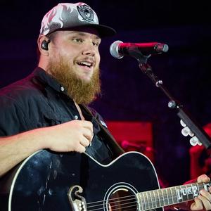 Luke Combs performing with a Raiders hat on