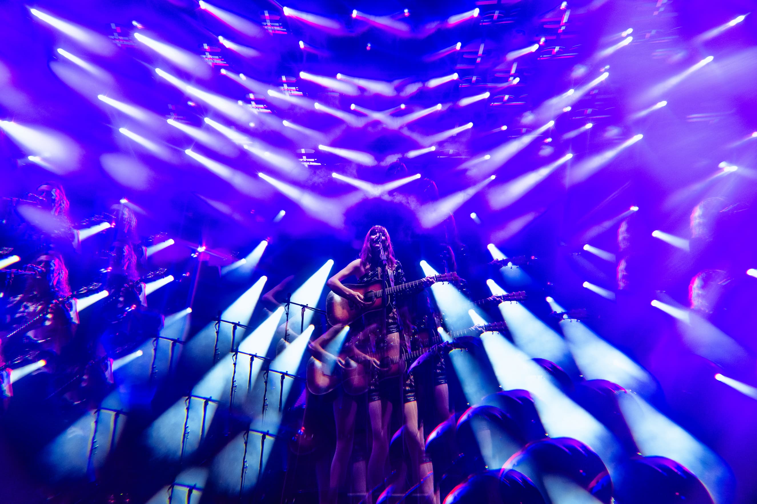 Molly Tuttle performing through a kaleidoscopic focus from the camera.