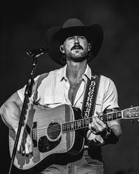 Riley Green performing in black and white