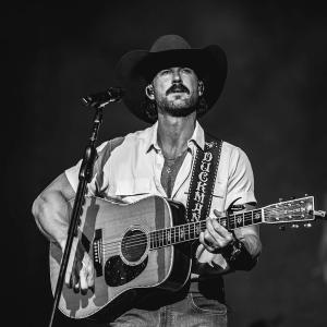 Riley Green performing in black and white