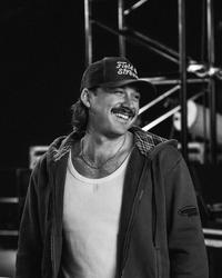 Morgan Wallen smiling while backstage in black-and-white photo