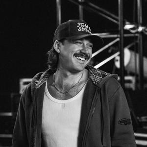 Morgan Wallen smiling while backstage in black-and-white photo