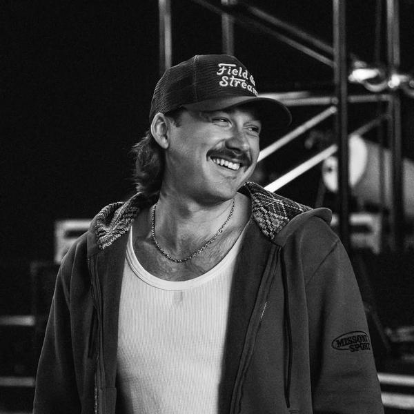 Morgan Wallen smiling while backstage in black-and-white photo