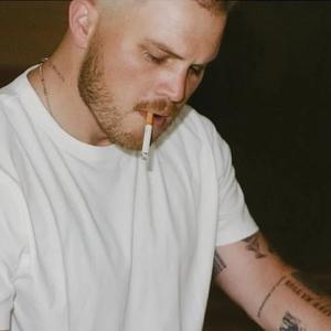 Zach Bryan playing piano