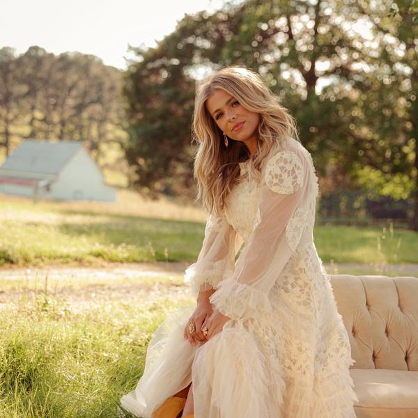 Anne Wilson sat in a meadow