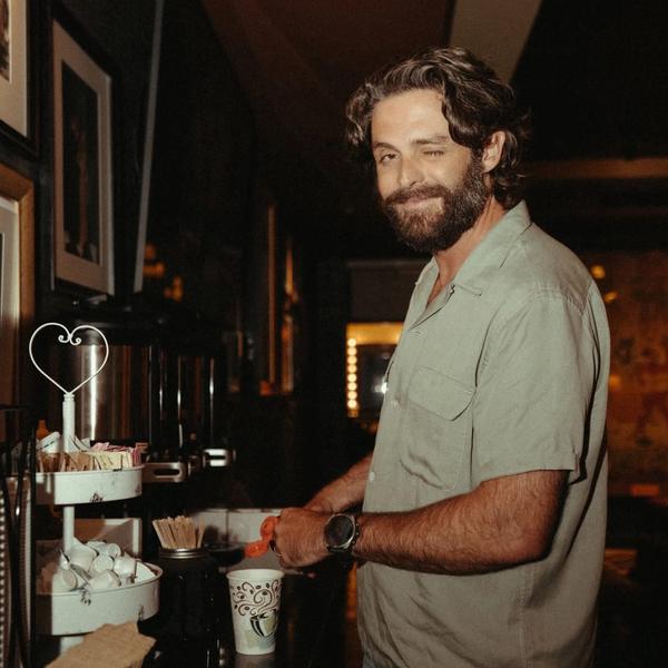 Thomas Rhett pouring himself a coffee