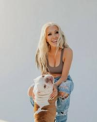 Bunnie XO holding a dog