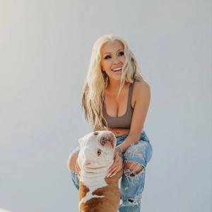 Bunnie XO holding a dog