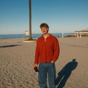 Forrest Frank holding coffee on the beach