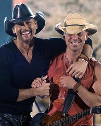 Kenny Chesney smiling with Tim McGraw