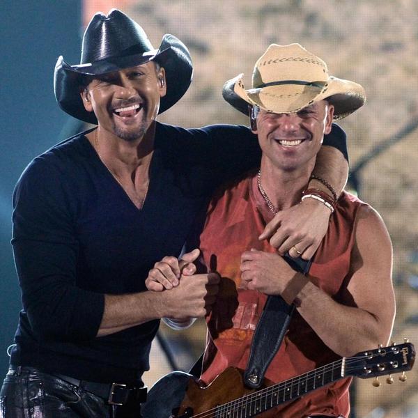 Kenny Chesney smiling with Tim McGraw