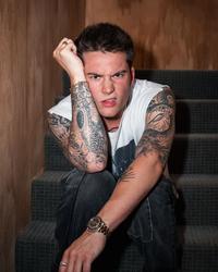 Cameron Whitcomb scowling on steps