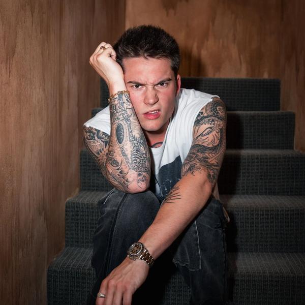 Cameron Whitcomb scowling on steps