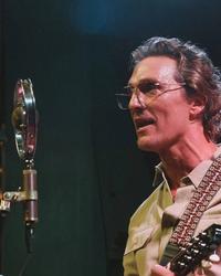 Matthew McConaughey performing with a retro mic