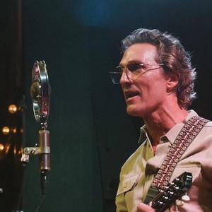 Matthew McConaughey performing with a retro mic