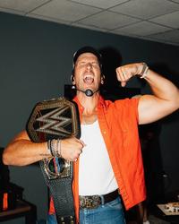 Russell Dickerson holding a WWE belt