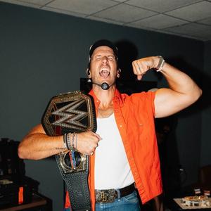 Russell Dickerson holding a WWE belt