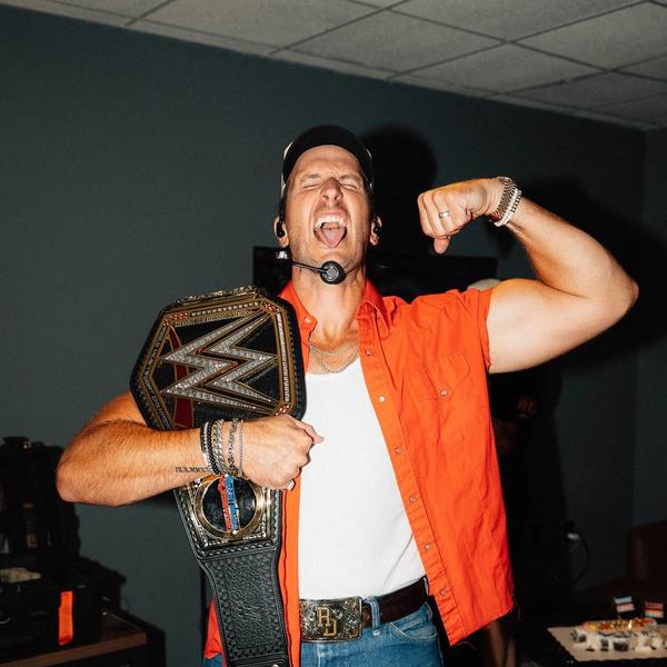 Russell Dickerson holding a WWE belt
