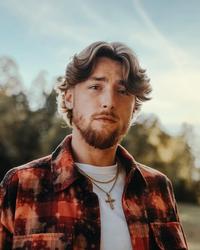 Bailey Zimmerman wearing flannel against a rural backdrop