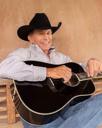 George Strait smilin’ and chillin’ with a guitar