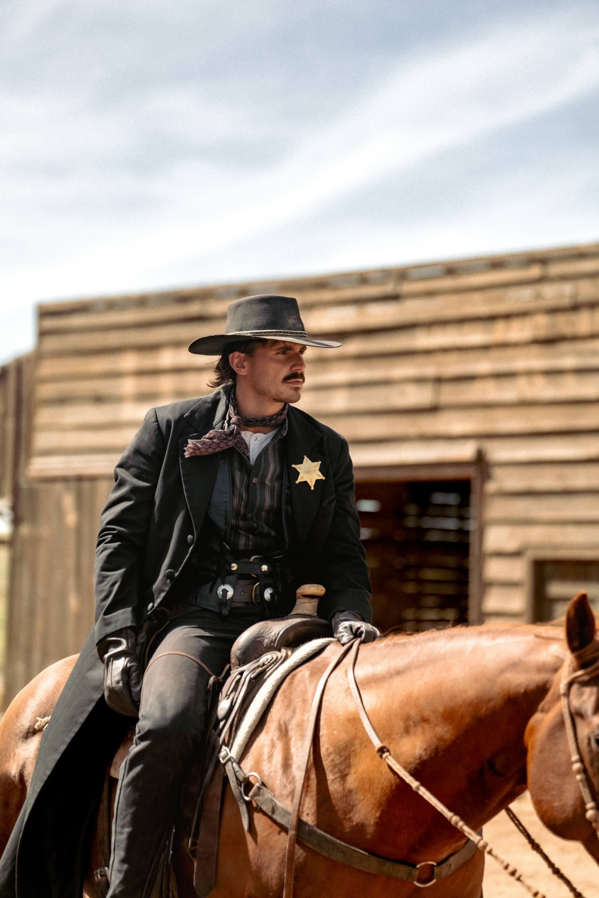 Tucker Wetmore riding a horse like a sheriff