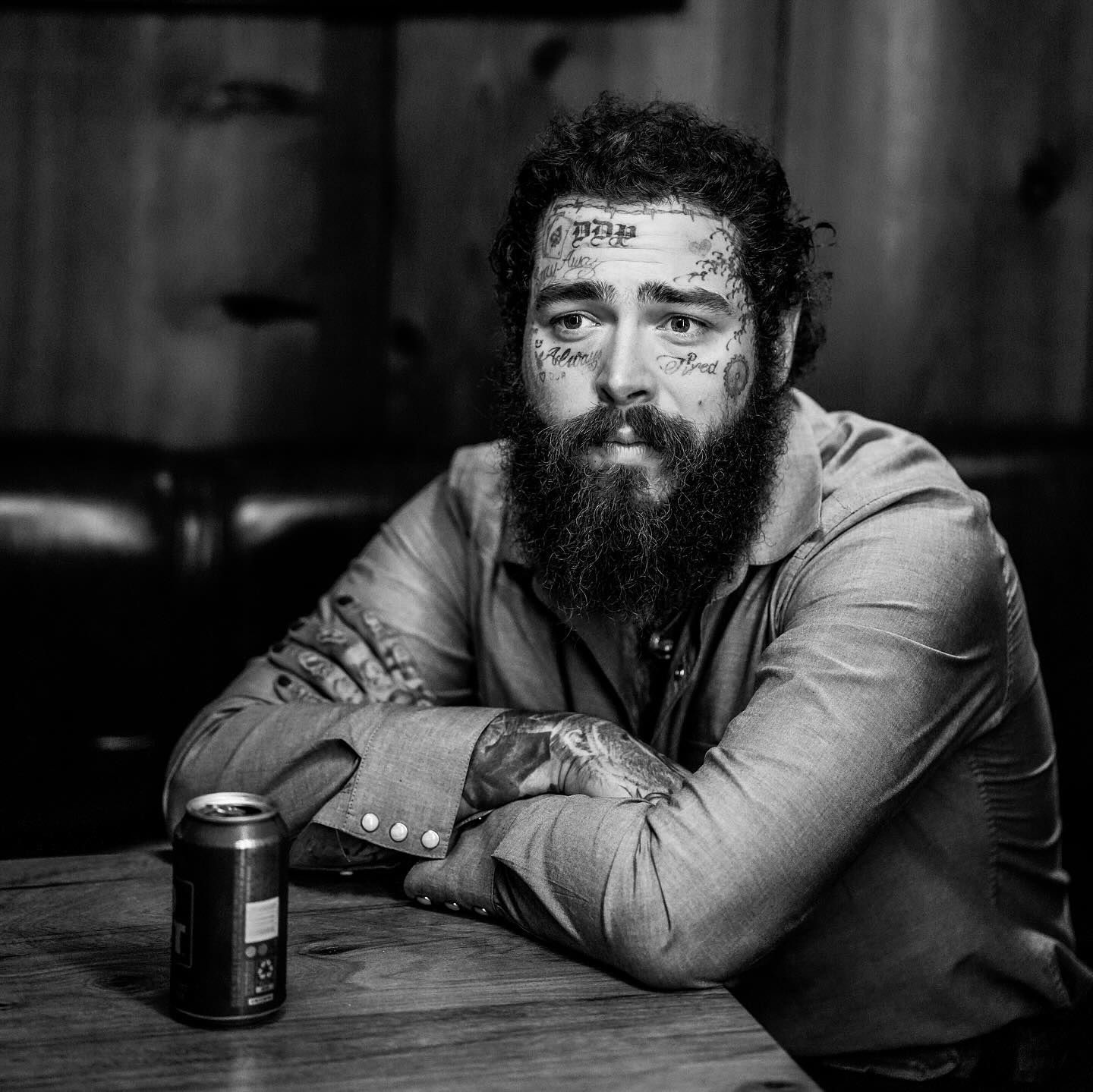 Post Malone sat drinking a beer