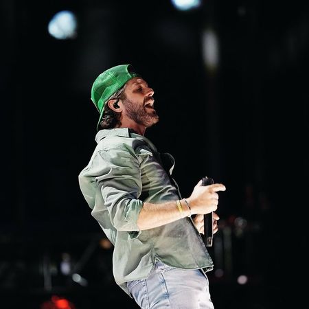 Thomas Rhett performing in a green hat