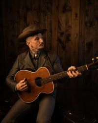 Benjamin Tod holding a guitar