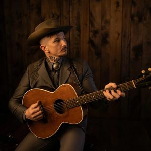 Benjamin Tod holding a guitar