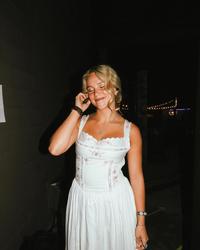 Avery Anna smiling in a dress