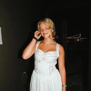 Avery Anna smiling in a dress