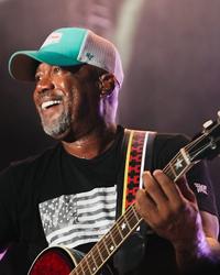 Darius Rucker smiling while performing