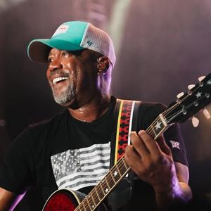 Darius Rucker smiling while performing