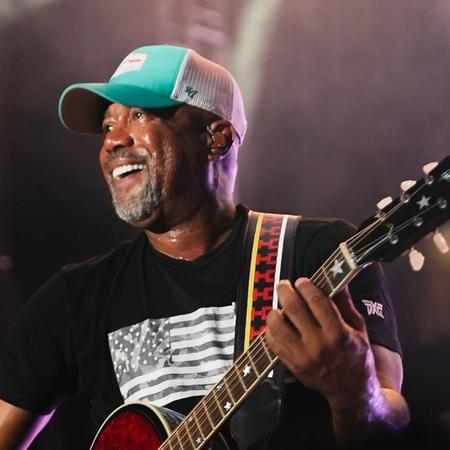Darius Rucker smiling while performing