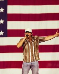 Morgan Wallen performing in front of the US flag in Glendale, Arizona