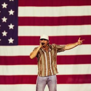 Morgan Wallen performing in front of the US flag in Glendale, Arizona