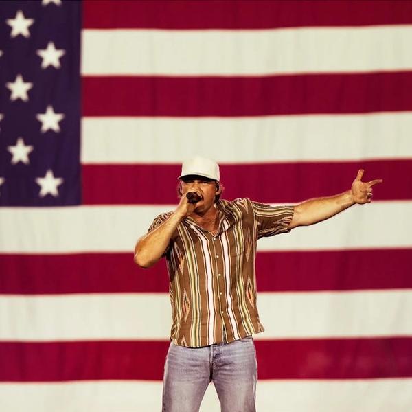 Morgan Wallen performing in front of the US flag in Glendale, Arizona