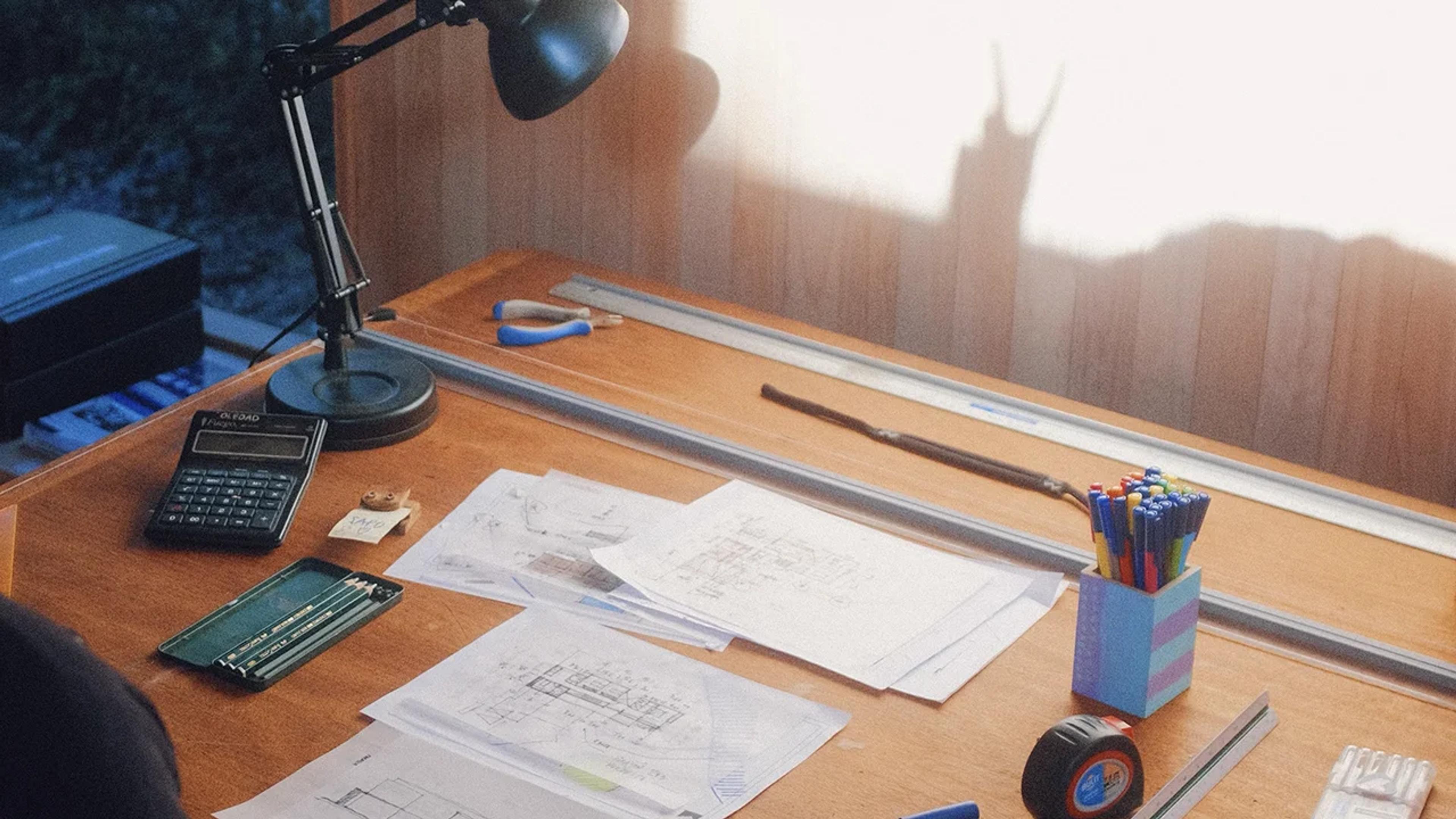 a work desk with papers and stationary